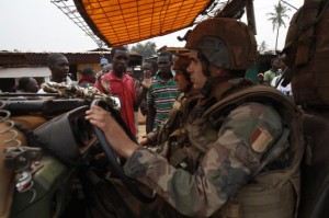 Angry young men complain to French soldiers in patrol in the pro-Christian area of Bangui