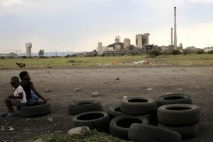 Children play on second-hand tyres outside Lonmin Mine at Marikana's Ikaneng township in Rustenburg