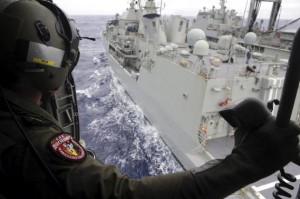 Leading Seaman Aircrewman Joel Young looks out from Tiger75, an S-70B-2 Seahawk helicopter, after it launched from HMAS Toowoomba as it continues the search in the southern Indian Ocean for the missing Malaysian Airlines flight MH370