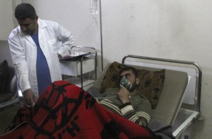 A man breathes through an oxygen mask inside a field hospital in Kfar Zeita village in the central province of Hama