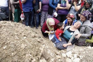 Women mourn during the funeral of a miner who died in a fire at a coal mine, at a cemetary in Soma, a district in Turkey's western province of Manisa