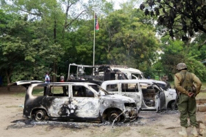 Wreckages of burnt cars are seen outside Mpeketoni police station after unidentified gunmen attacked coastal Kenyan town of Mpeketoni