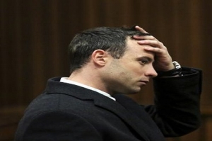 Oscar Pistorius gestures during his trial for the murder of his girlfriend Reeva Steenkamp, in Pretoria