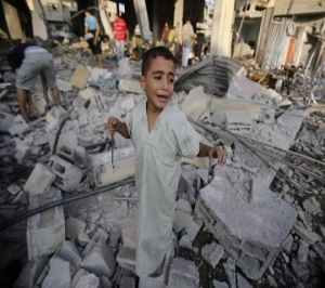 Palestinian boy cries as he stands in a debris-strewn street near his family's house in Rafah in the southern Gaza Strip