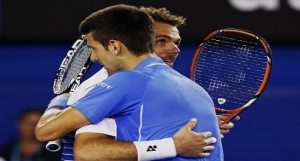 Djokovic of Serbia hugs Wawrinka of Switzerland after winning their men's singles semi-final match at the Australian Open 2015 tennis tournament in Melbourne