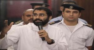 Activist Alaa Abdel Fattah speaks in front of a judge at an Egyptian Court during his trial