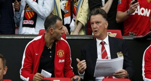 Manchester United's manager Van Gaal speaks with Giggs before their friendly soccer match against Valencia in Manchester
