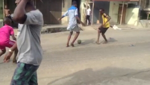 Idle teens play football on deserted streets of Lagos