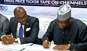 Executive Chairman/ CEO Channels Media Group, Mr. John Momoh signing the partnership agreement with The Managing Director and Chief Executive of the FMDQ OTC Securities Exchange, Mr Onadele Koko, 