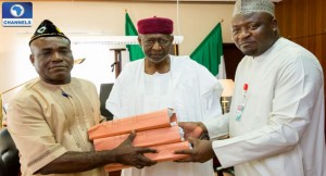 Senator Ita Enang handing over the budget to the Chief of Staff, Abba Kyari