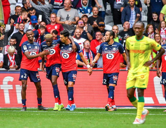 Osimhen is congratulated by his teammates after scoring his second goal during the