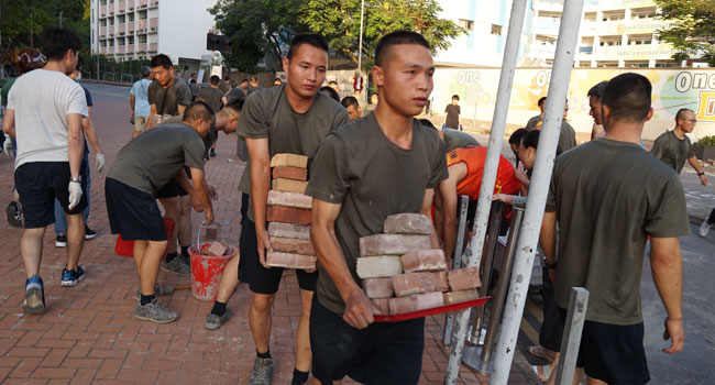 Personnel from the Chinese People's Liberation Army barracks in Hong Kong emerged on to the city streets on November 16, 2019, to help the clean-up after a week of violence and disruption caused by pro-democracy protesters. Kris Cheng / HKFP / AFP