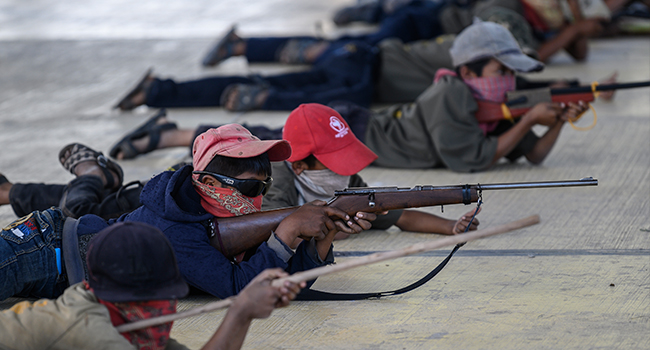 Children are tought to use weapons by the Regional Coordinator of Community Authorities (CRAC-PF) community police force at a basketball court in the village of Ayahualtempan, Guerrero State, Mexico, on January 24, 2020. Pedro PARDO / AFP