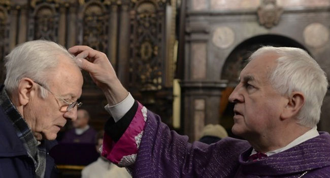 Bishop Jan Szkodon sprinkles head of the faithful with ashes, during the celebration of the Ash Wednesday and a Holy Masse for the Homeland and the victims of the disaster in Smolensk monthly anniversary of the tragedy, at the Royal Wawel Cathedral. Krakow, Poland. Wednesday, February 10, 2016.