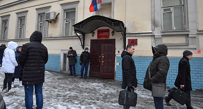 People stand outside the Basmanny Court following an evacuation due to the warning of a planted bomb in Moscow on February 6, 2020. Yuri KADOBNOV / AFP