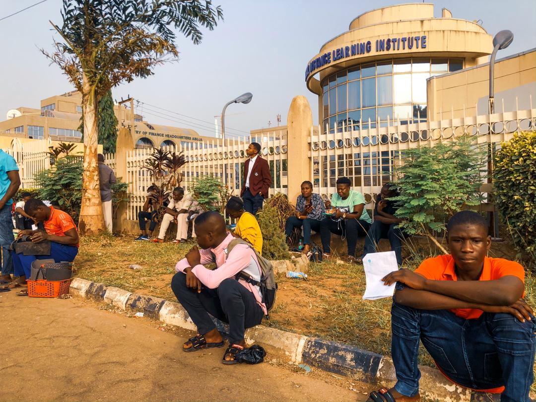 Candidates of the Joint Admissions and Matriculation Board (JAMB) wait outside a JAMB CBT Centre in Abuja on Monday March 16th, 2020. Photo: Sodiq Adelakun/ChannelsTV