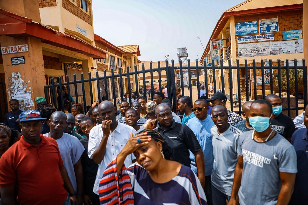 Store owners stand outside their closed stores in Dutse, Abuja after being closedown by task force over unknown cause on Wednesday, March 18th, 2020. Photo: Sodiq Adelakun / Channels TV
