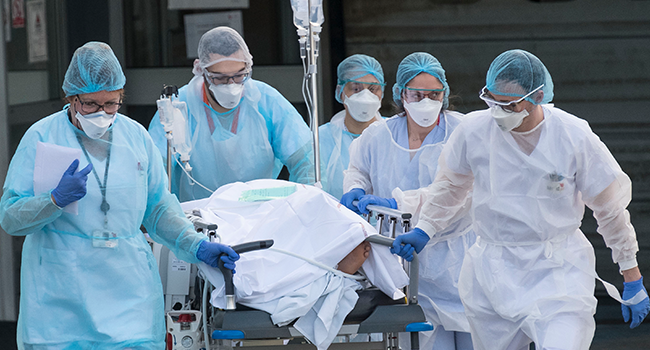 Medical staff push a patient on a gurney to a waiting medical helicopter at the Emile Muller hospital in Mulhouse, eastern France, to be evacuated on another hospital on March 17, 2020, amid the outbreak of the new Coronavirus, COVID-19. SEBASTIEN BOZON / AFP