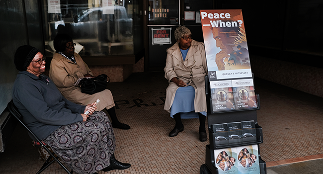 Woman display Jehovah's Witness literature along a street on February 26, 2020 in Orangeburg, South Carolina.SPENCER PLATT / GETTY IMAGES NORTH AMERICA / AFP