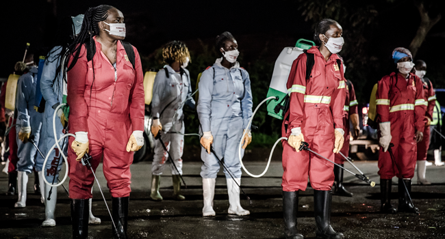 Members of a privately-funded NGO working with county officials wearing protective gather on April 15, 2020, during the dusk-to-dawn curfew imposed by the Kenyan Government, to receive instructions on how to fumigate and disinfect the streets and the stalls at Parklands City Park Market in Nairobi to help curb the spread of the COVID-19 coronavirus. LUIS TATO / AFP