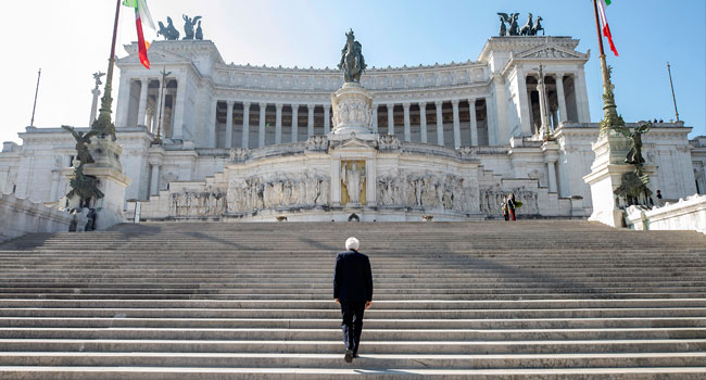 This photo taken and handout on April 25, 2020 by the press office of the presidential Quirinale Palace shows Italian President Sergio Mattarella arriving to place a wreath on the tomb of the unknown soldier at the Altare della Patria. Handout / Quirinale Press Office / AFP