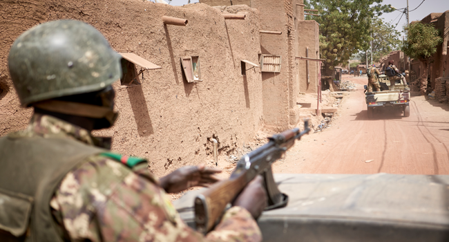 Troops of the Malian army patrol the ancient town of Djenne in central Mali on February 28, 2020. A week earlier Mali's Prime Minister announced the dismantling of the security checkpoints organized by the traditional militia hunters Dan Na Ambassagou from Dogon country. MICHELE CATTANI / AFP