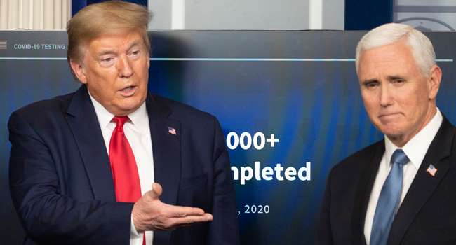US President Donald Trump (L) gestures to Vice President Mike Pence speaks during the daily briefing on the novel coronavirus, which causes COVID-19, in the Brady Briefing Room of the White House on April 17, 2020, in Washington, DC. JIM WATSON / AFP