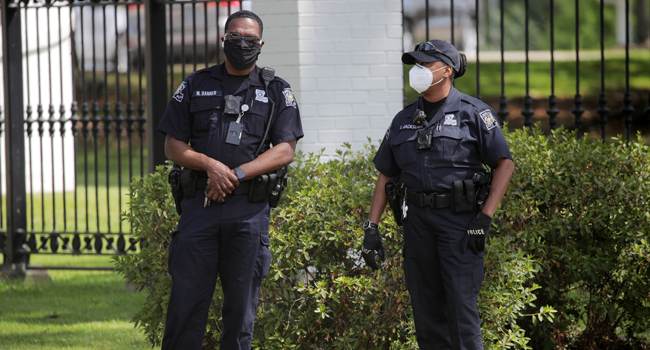 Members of the police stand by as protestors gather outside the Louisiana State Governor's mansion during a rally against Louisiana's stay-at-home order and economic shutdown on April 17, 2020 in Baton Rouge, Louisiana. Chris Graythen/Getty Images/AFP