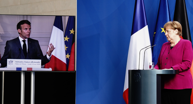German Chancellor Angela Merkel listens during a joint press conference with French President Emmanuel Macron, who attends via video link, at the Chancellery in Berlin, Germany, on May 18, 2020 on the effects of the novel coronavirus COVID-19 pandemic. Kay NIETFELD / POOL / AFP
