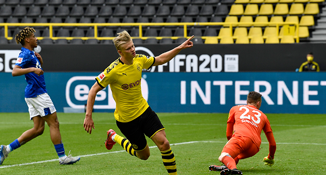 Dortmund's Norwegian forward Erling Braut Haaland celebrates after scoring the opening goal during the German first division Bundesliga football match BVB Borussia Dortmund v Schalke 04 on May 16, 2020 in Dortmund, western Germany as the season resumed following a two-month absence due to the novel coronavirus COVID-19 pandemic. Martin Meissner / POOL / AFP