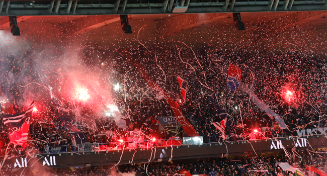 In this file photo taken on February 09, 2020 Fans light flares in the stands during the French L1 football match between Paris Saint-Germain (PSG) and Lyon (OL) at the Parc des Princes stadium in Paris. GEOFFROY VAN DER HASSELT / AFP