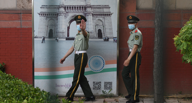 Two Chinese paramilitary police officers patrol outside the Indian embassy in Beijing on June 16, 2020. GREG BAKER / AFP