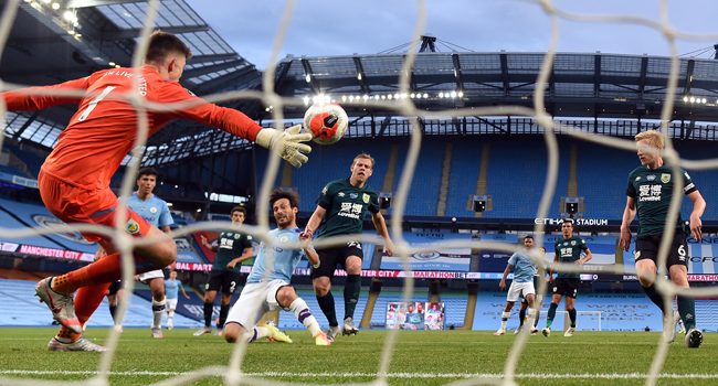 Manchester City's Spanish midfielder David Silva scores the fourth goal past Burnley's English goalkeeper Nick Pope during the English Premier League football match between Manchester City and Burnley at the Etihad Stadium in Manchester, north west England, on June 22, 2020. Michael REGAN / POOL / AFP