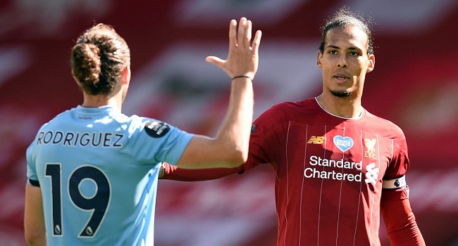 Burnley's English striker Jay Rodriguez (L) and Liverpool's Dutch defender Virgil van Dijk after the English Premier League football match between Liverpool and Burnley at Anfield in Liverpool, north west England on July 11, 2020. (Photo by Oli SCARFF / POOL / AFP)
