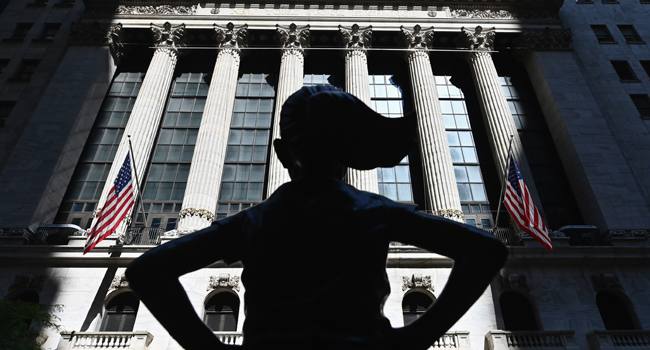 In this file photo taken on June 29, 2020, The "Fearless Girl" statue stands in front of the New York Stock Exchange (NYSE) at Wall Street in New York City. Angela Weiss / AFP