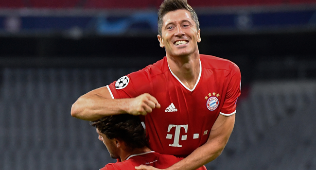 Bayern Munich's Polish forward Robert Lewandowski (up) celebrates with his teammate Bayern Munich's Spanish defender Alvaro Odriozola after scoring his team's fourth goal during the UEFA Champions League, second-leg round of 16, football match FC Bayern Munich v FC Chelsea in Munich, southern Germany on August 8, 2020. Tobias SCHWARZ / AFP