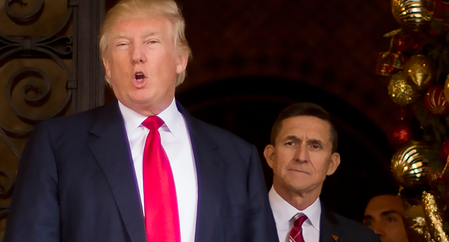 In this file photo taken on December 21, 2016 US President-elect Donald Trump (L) stands with Trump National Security Adviser designate Lt. General Michael Flynn (R) at Mar-a-Lago in Palm Beach, Florida. JIM WATSON / AFP