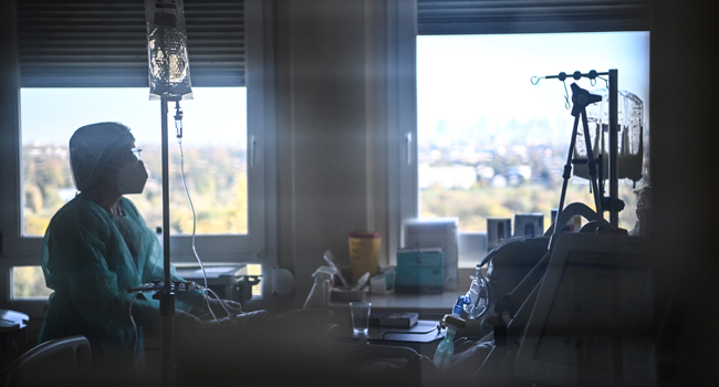 A nurse tends to a patient in an intensive care unit set up for those infected with the novel coronavirus, Covid-19, at the Centre Hospitalier de l'Europe in Le Port-Marly, near Paris on November 4, 2020. Anne-Christine POUJOULAT / AFP