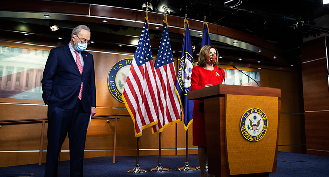: Senate Minority Leader Chuck Schumer (D-NY) listens as Speaker of the House Nancy Pelosi (D-CA) speaks during a press conference on Capitol Hill on December 20, 2020 in Washington, DC. Tasos Katopodis/Getty Images/AFP