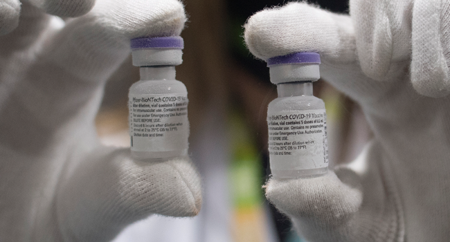 A laboratory technician holds a Pfizer-BioNTech Covid-19 vaccines at the Bidafarma wholesale distribution cooperative in Santa Fe, on the outskirts of near Granada, on January 21, 2021. JORGE GUERRERO / AFP