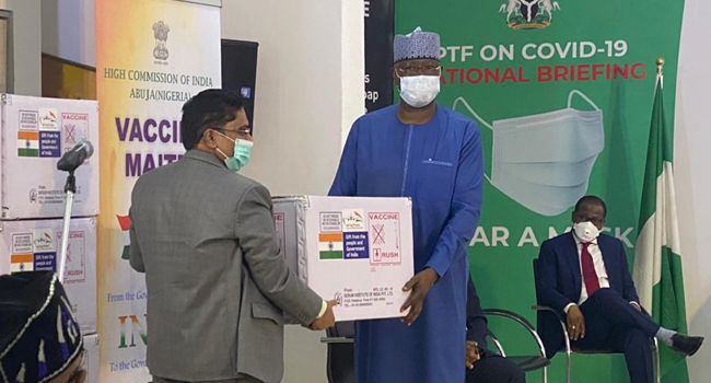 Chairman of the Presidential Task Force on COVID-19, Boss Mustapha, receives a box of vaccine from a representative of the Indian government on April 6, 2021.