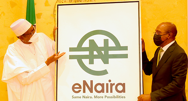 President Muhammadu Buhari and CBN Governor, Godwin Emefiele, pose for a picture at the launch of the eNaira at the State House in Abuja on October 25, 2021. Sunday Agaheze/State House