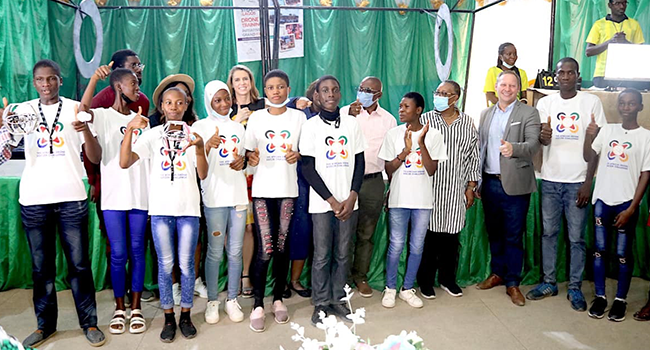 The winning Pace Setters Team from Ijaiye Housing Estate Senior Grammar School in a group photograph with U.S. Consulate Public Affairs Officer Stephen Ibelli (third right) and U.S. Consulate Deputy Public Affairs Officer Jenny Foltz (second row, third left) with Lagos State Commissioner for Education Folasade Adefisayo during the closing ceremony of the drone soccer competition in Lagos on February 5, 2022.