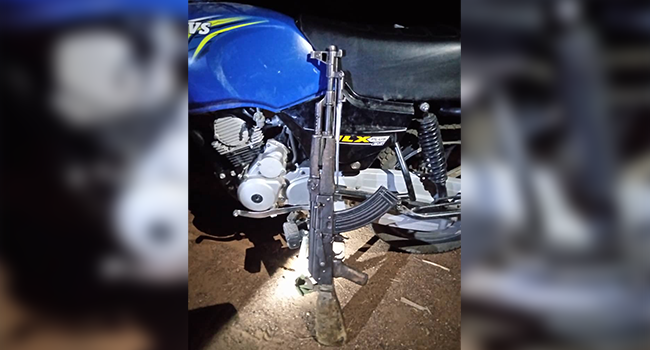This photo shows a rifle resting against a motorcycle. Both were reportedly recovered from Boko Haram terrorists by hunters in the North-East region.