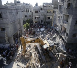 Palestinians gather as rescue workers search for victims under the rubble of a house in Rafah