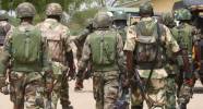 A file photo of Nigerian soldiers sitting on a military pick-up truck at a military base.