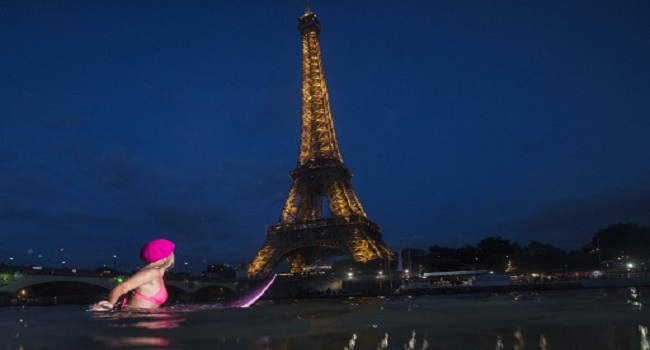 Surfing The Seine: Climate Campaigner Paddles In Paris