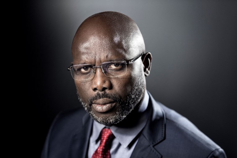 FILES) This file photo taken on September 25, 2017 shows former football player and candidate in Liberia's presidential elections, George Weah posing during a photo session in Paris. Weah was sworn in as Liberia's new president on January 22, 2018, in the country's first transition between democratically-elected leaders since 1944. / AFP PHOTO / JOEL SAGET