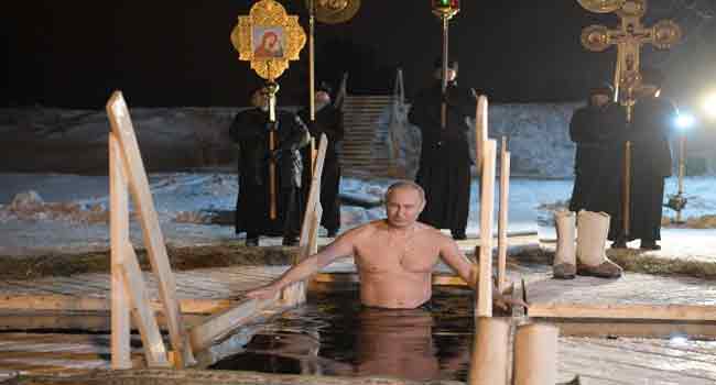 Putin Takes Icy Plunge As Orthodox Believers Mark Epiphany Channels Television