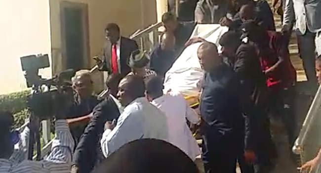 VIDEO: Olisa Metuh Wheeled To Court On Stretcher